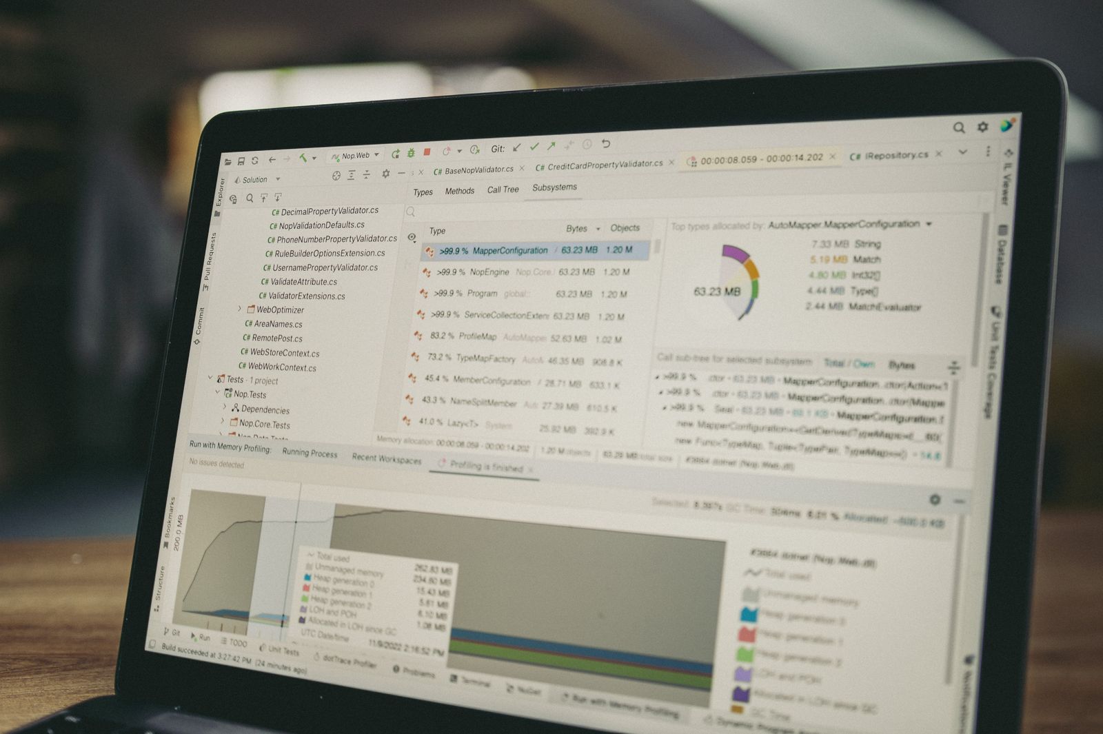 Laptop displaying a software dashboard and data analysis interface